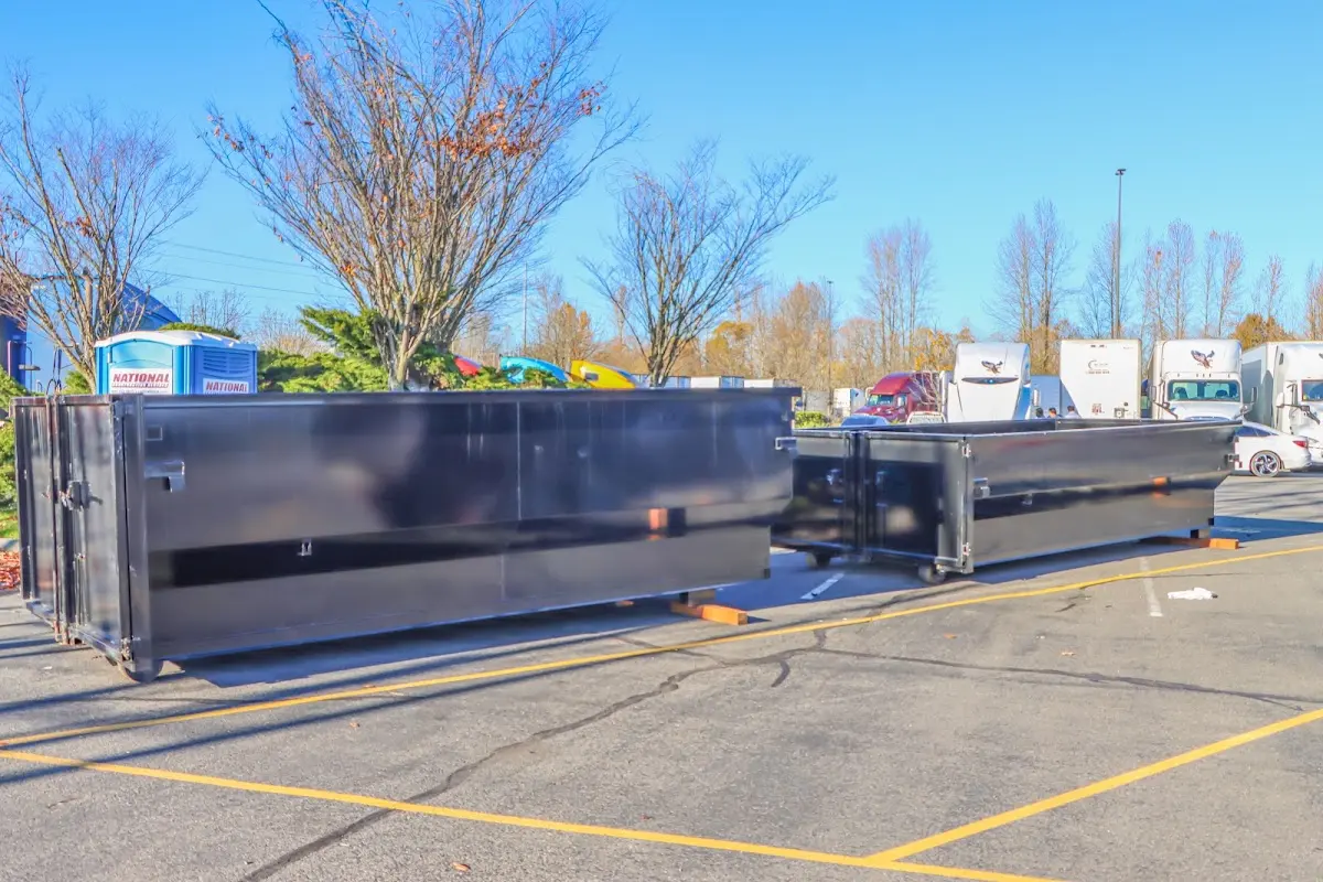 Professional dumpster rental service with roll-off container on residential driveway in Rio Rancho
